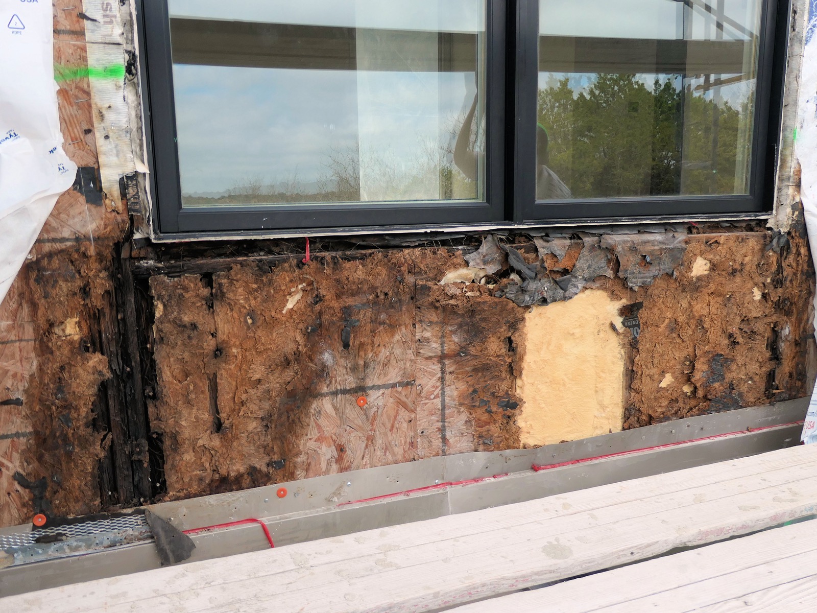 Water damage to exterior wall caused by defective window installation