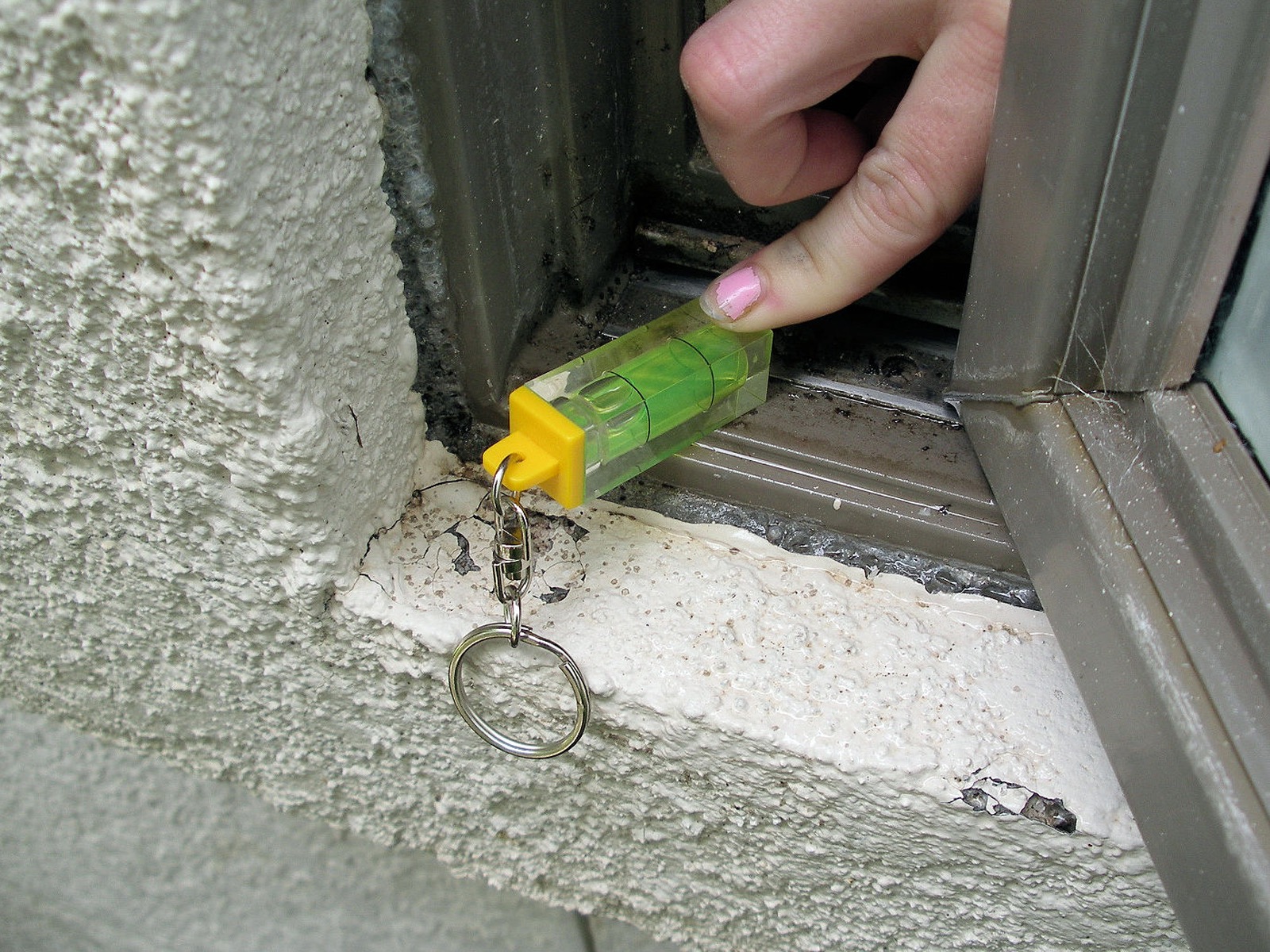 Negative slope of window frame collects and holds water and is more likely to leak